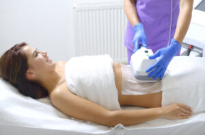Endosphere therapy of female body by cosmetologist in beauty salon