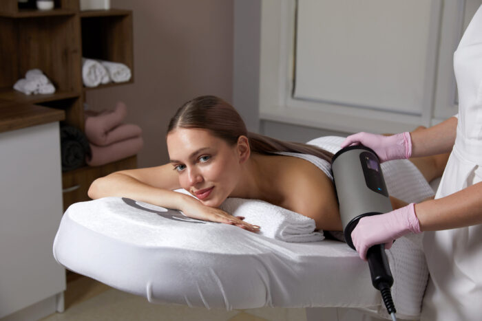 Endosphere therapy of female body by cosmetologist in beauty salon